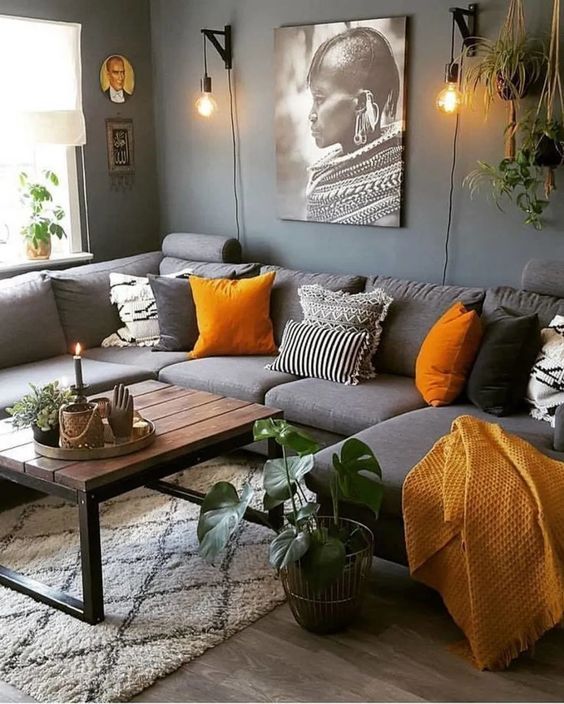 modern dark grey couch with orange pillows and dark grey wall