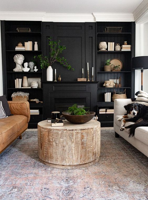 black bookshelves around black fireplace