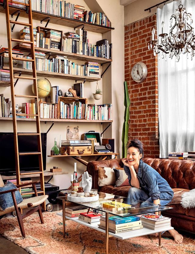 living room with DIY industrial bookshelf and brown leather sofa